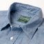 A close up photo of the blue collar, white buttons green Gitman Vintage tag.