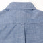 The back of the blue chambray work shirt with a locker loop and the back of the collar.