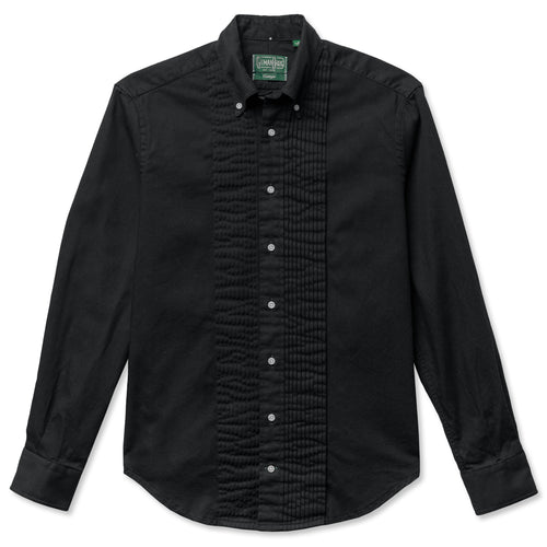 A classy formal black button down tuxedo shirt oxford, with and overdyed fabric, white buttons, a ruffled placket and barrel cuffs.
