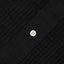 The black shirt placket with a white button and ruffles on each side of the placket.